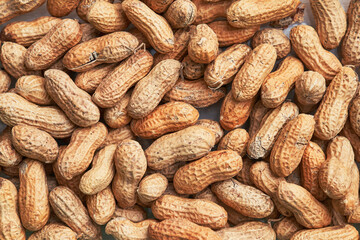 Healthy roasted unpeeled peanuts. Brown nuts texture