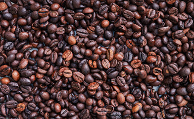 Brown and black coffee beans. Roasted arabic espresso coffee grains.