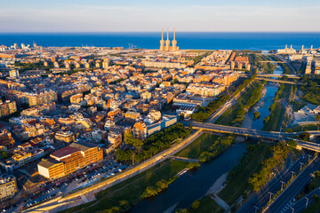 Aerial view of seaside areas of Badalona and Sant Adria de Besos on banks of Besos river on summer day, Catalonia, Spain