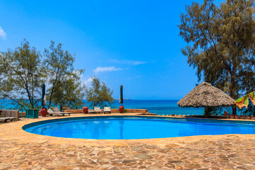 Swimming pool overlooking ocean. Tropical vacations concept