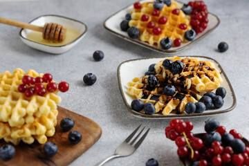 breakfast served - waffles with berries and honey