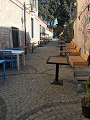 Fototapeta na wymiar Retro style cafe in the street with cobblestones