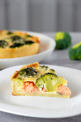 Traditional French quiche Lorraine pie with broccoli, salmon and soft cheese. Recipe of homemade fish pie of Mediterranean cuisine. Healthy eating or low card diet.