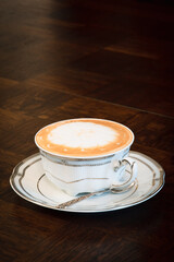 Cup of coffee latte on wooden table