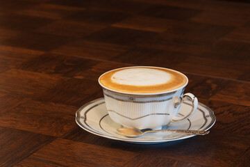 Cup of coffee latte on wooden table