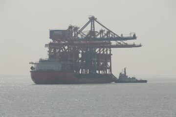 Grab Ship Unloader being transported in large vessel.