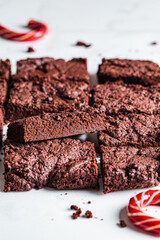 Vegan brownie squares on a white table.