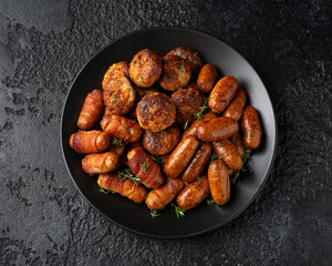 Pigs in Blankets, cocktail sausages and meatballs on plate. Party food
