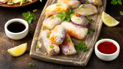 Fried Vegan spring rolls, rice paper dumplings with sweet and purple cabbage, rice noodles and carrots