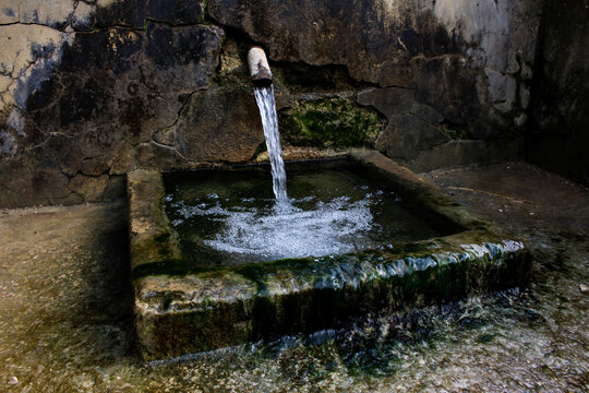 A Running Fresh Natural Water Fountain Flowing Out Steel Faucet  Tube Into The Mountain Of Oued Zitoun, Bizerte