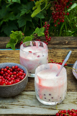 Whipped cream dessert with red currants on a summer day
