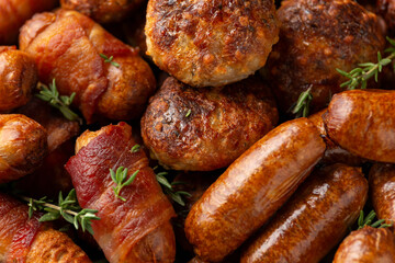 Pigs in Blankets, cocktail sausages and meatballs on plate. Party food