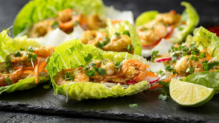 Lettuce wraps loaded with Spicy prawn, shrimp and rice vermicelli noodles, Asian style finger party food