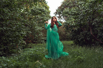 Young woman in green dress in the park