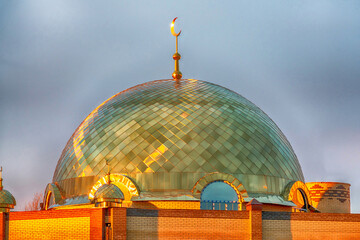 Golden domes of a mosque under construction in Abakan. Golden hour