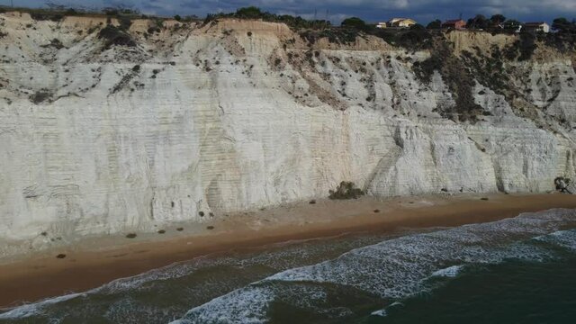 Pull Away from White Cliffs and Waves on Slender Beach in the Mediterranean Sea
