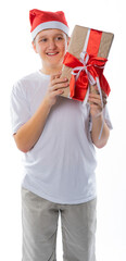 boy in jeans, t-shirt and santaclaus hat holds gifts. isolated white background