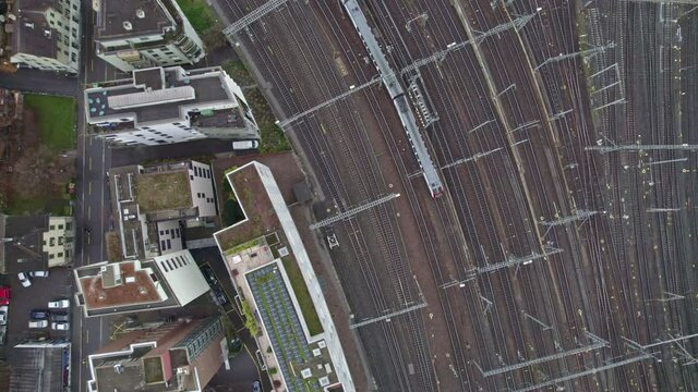 Aerial view of City of Z&uuml;rich on a rainy autumn day with track field of the Z&uuml;rich main railway station. Movie shot November 28th, 2021, Zurich, Switzerland.