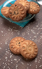 Homemade oatmeal cookies with flax and sesame seeds on white wooden table, copy space. Healthy vegan oat cookies