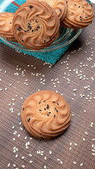 Homemade oatmeal cookies with flax and sesame seeds on white wooden table, copy space. Healthy vegan oat cookies