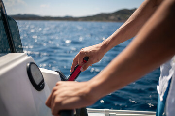 Man driving a boat at sea on a sunny day