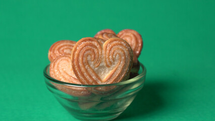 Delicious homemade heart shaped cookie on a color background. Top View. Place for text.