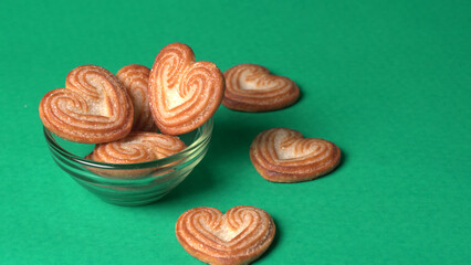 Delicious homemade heart shaped cookie on a color background. Top View. Place for text.