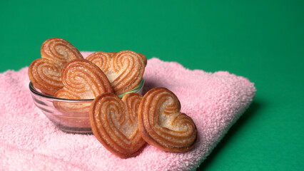 Delicious homemade heart shaped cookie on a color background. Top View. Place for text.
