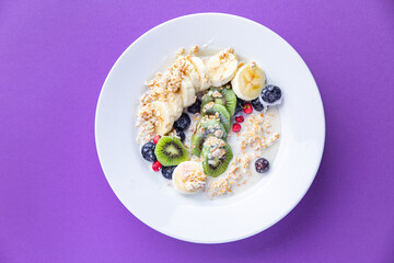oatmeal fruit breakfast milk, banana, kiwi, berrie, blueberrie meal snack on the table copy space food background