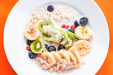 oatmeal fruit breakfast milk, banana, kiwi, berrie, blueberrie meal snack on the table copy space food background