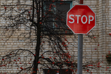 A stop sign indicating the place in front of which it is necessary to stop vehicles and show...