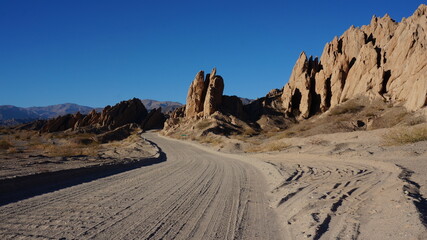 beautiful rock formations next to a gravel road
