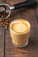 Cortado coffee with coffee beans next to it. Traditional coffee in Spain.