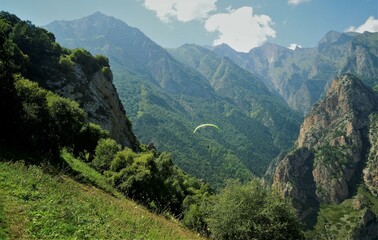 Fototapeta na wymiar A gift for a friend is a paragliding flight in the Chegem Gorge, in one of the most beautiful places in the Caucasus.