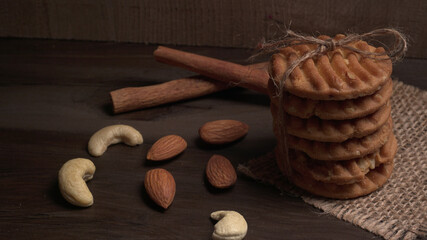 Homemade oatmeal cookies with flax and sesame seeds on white wooden table, copy space. Healthy vegan oat cookies