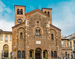 Fototapeta na wymiar The façade of the Catholic church of San Sepolcro, originally built in 12th century, in Romanesque style, part of the Ambrosian Library, Milan city center, Lombardy region, Italy