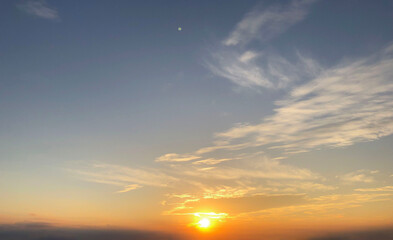 Sunset blue sky with sun and soft clouds