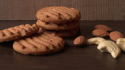 Homemade oatmeal cookies with flax and sesame seeds on white wooden table, copy space. Healthy vegan oat cookies