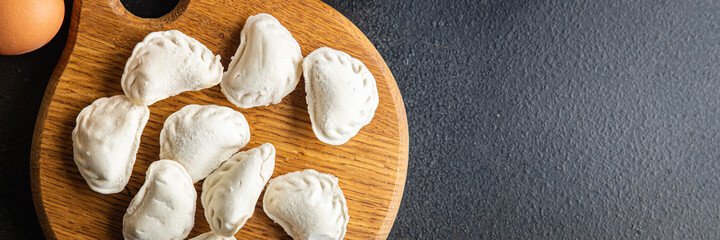 vareniki raw stuffed dumplings ready to cook meal snack on the table copy space food background