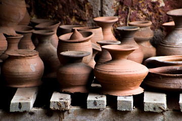 Fototapeta na wymiar Collection of clay pots and jars for sale.
