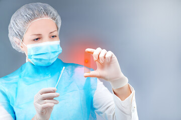 a nurse in a protective suit and a mask protects herself from viruses