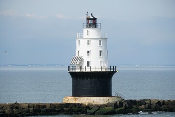 Fototapeta na wymiar The white and black lighthouse near Cape Henlopen Beach, Lewes, Delaware, U.S.A