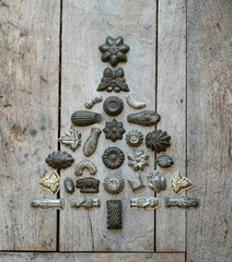 Vintage metal chocolate molds, cupcake baking molds in christmas tree shape on a wooden board