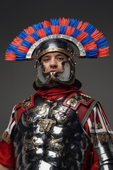 Proud roman centurion warrior with plumed helmet isolated on gray