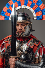 Imperial roman soldier with gladius against gray background