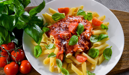 Composition with a plate of pasta penne rigate