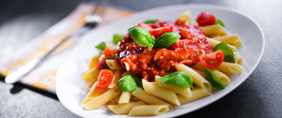 Composition with a plate of pasta penne rigate