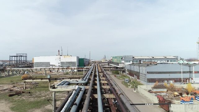 Complex engineering structures of a polymer plant. Summer drone shooting at the factory. Old factory from the times of the USSR