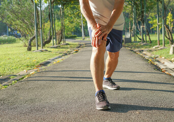 a senile man is stretching his legs before running or jogging, concept warm up exercise prevent injury in elderly people