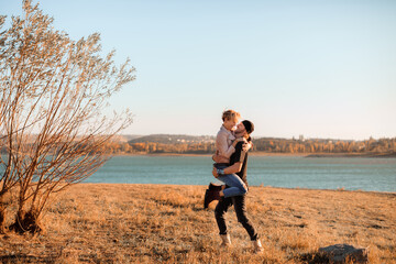 happy couple by the lake at sunset - Image